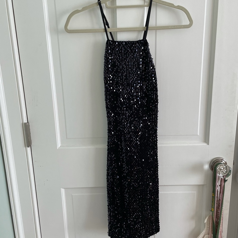 Black sequence mini dress with open back. Tag on